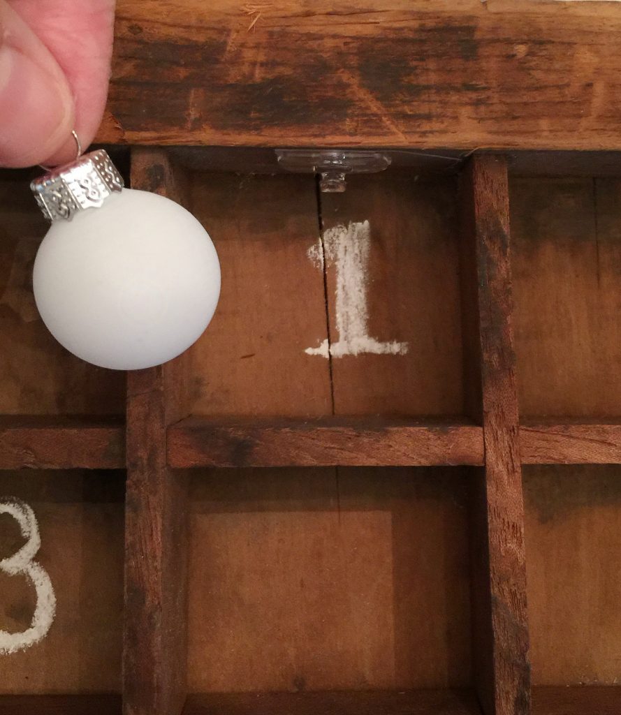 Hang tiny ornament for advent calendar