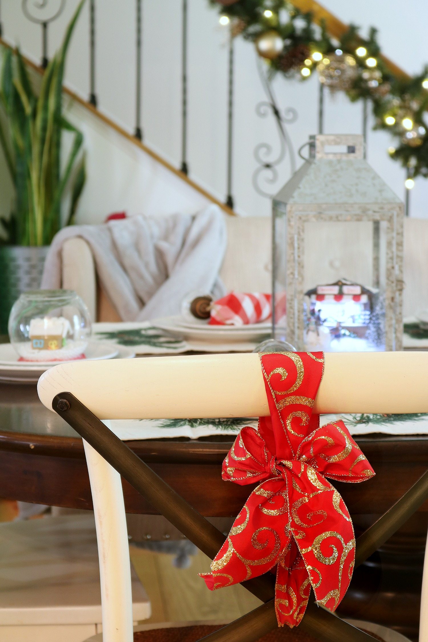 Red and gold ribbon tied to the back of chairs