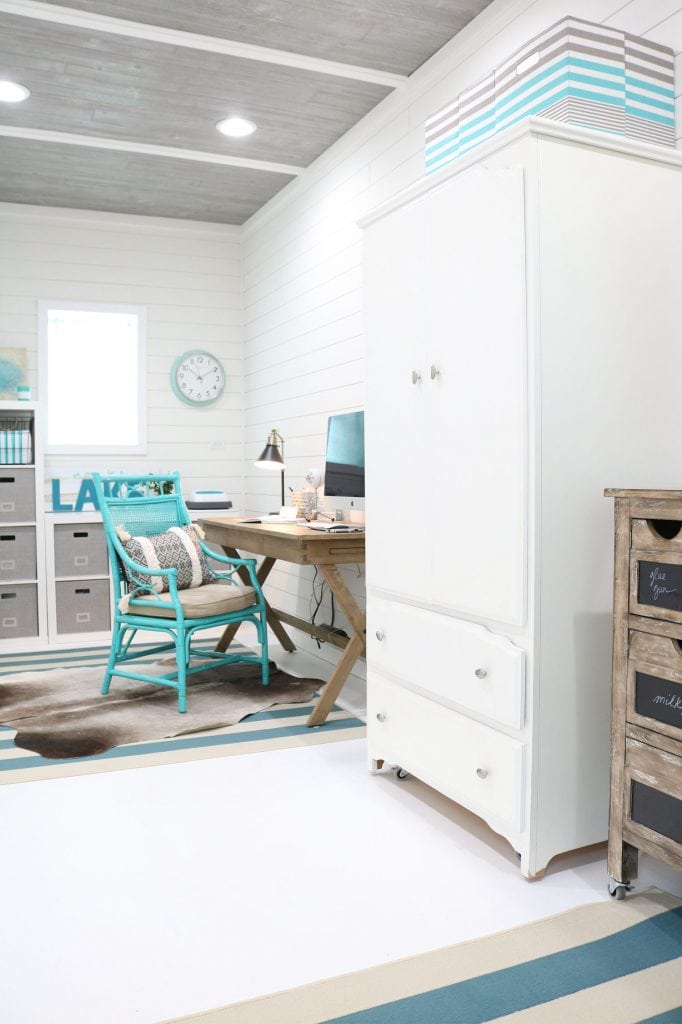 Home office in garage with shiplap and painted floors.