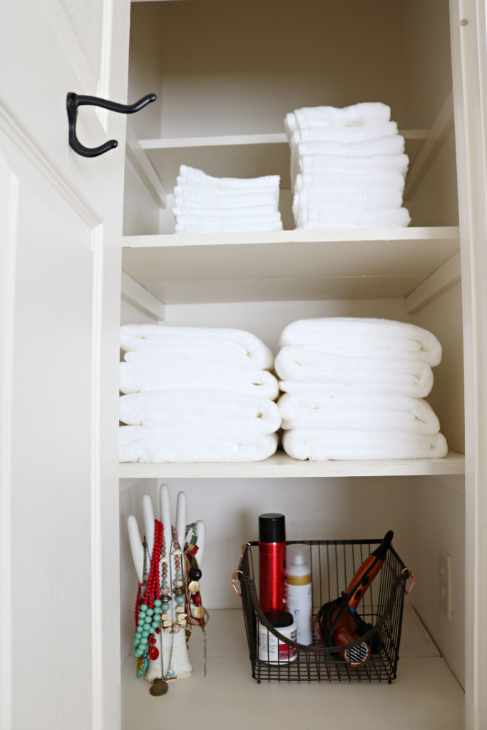 BHG towel closet update - fresh white towels and wire basket.